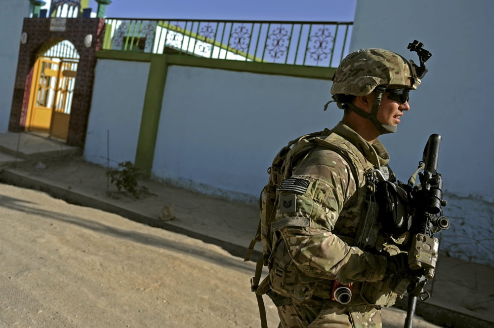 A soldier patrols the streets of Qalat City Afghanistan Canvas Art - Stocktrek Images (35 x 23)