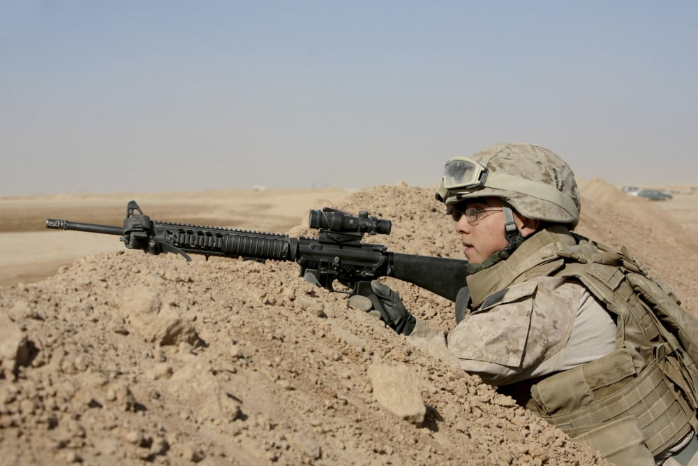 A soldier positions himself on top of a berm to provide security in Afghanistan Canvas Art - Stocktrek Images (34 x 23)