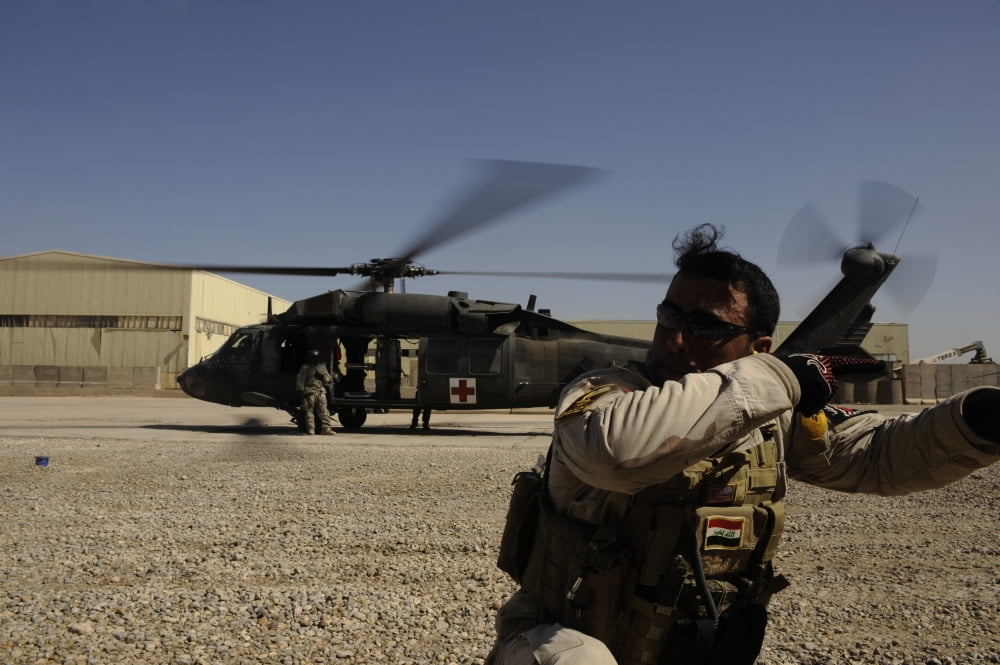 A soldier provides security after exiting a UH-60 Blackhawk helicopter Canvas Art - Stocktrek Images (34 x 23)