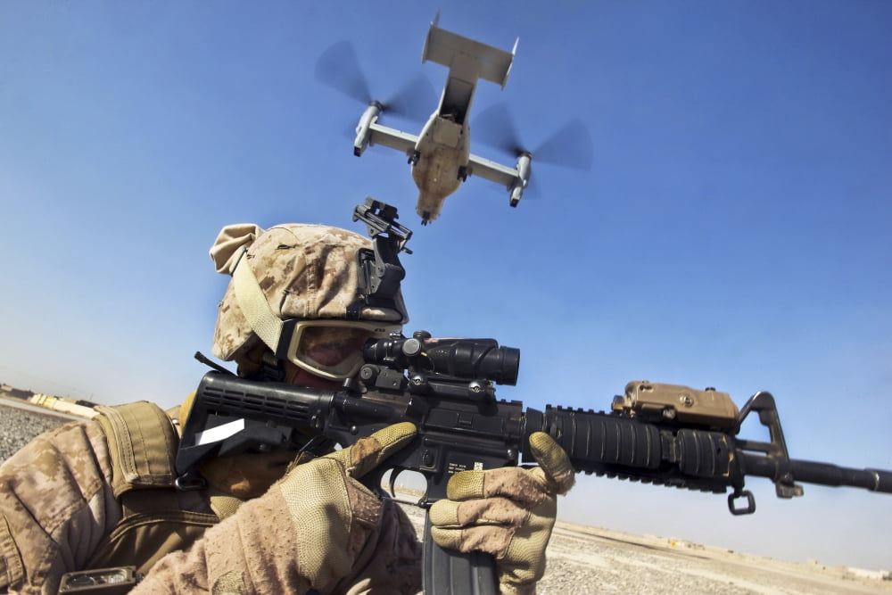 A soldier provides security as an MV-22 Osprey lands in Afghanistan Canvas Art - Stocktrek Images (35 x 23)