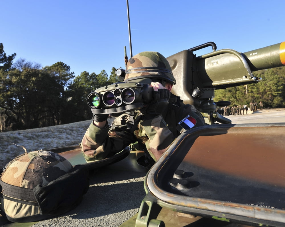 A soldier scans the horizon through a pair of binoculars Canvas Art - Stocktrek Images (32 x 26)