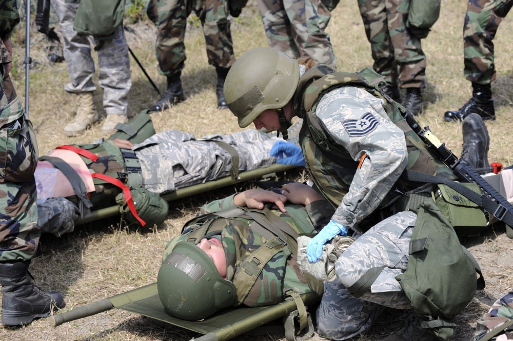 A soldier tends to a victim following a simulated attack Canvas Art - Stocktrek Images (34 x 23)