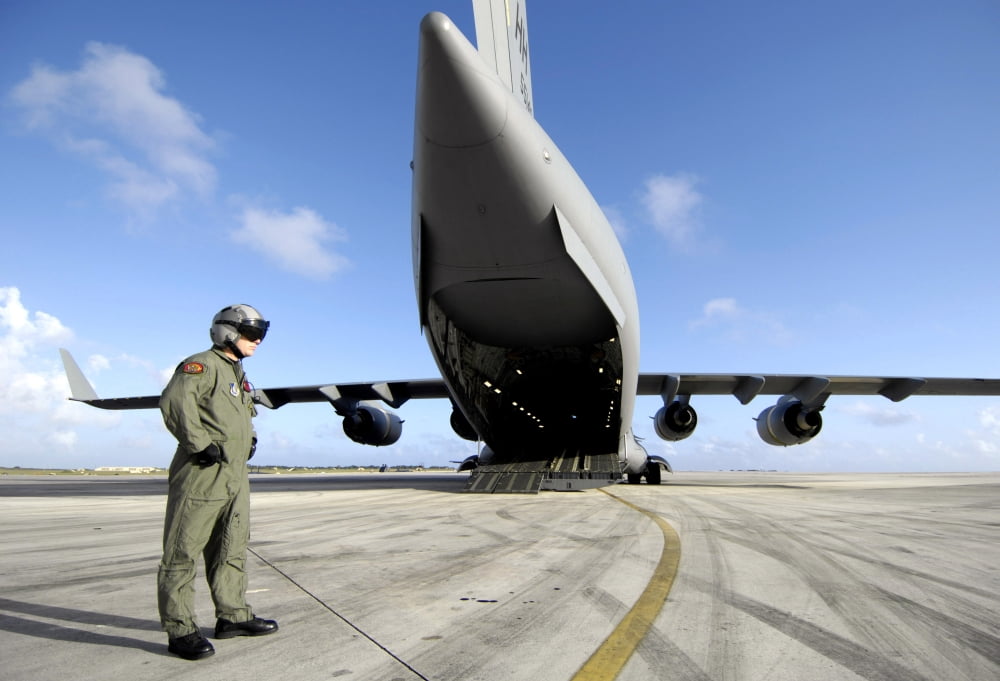 A soldier waits for his C-17 Globemaster III to launch Canvas Art - Stocktrek Images (34 x 23)