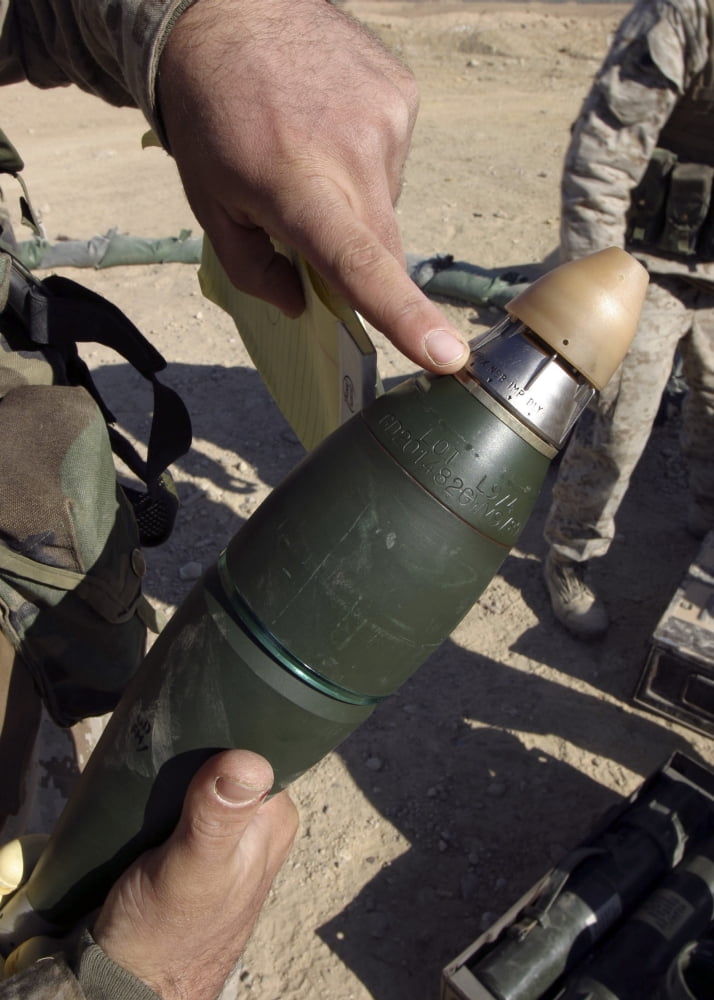 A squad leader points to a delay setting on an 81mm mortar round Canvas Art - Stocktrek Images (24 x 33)