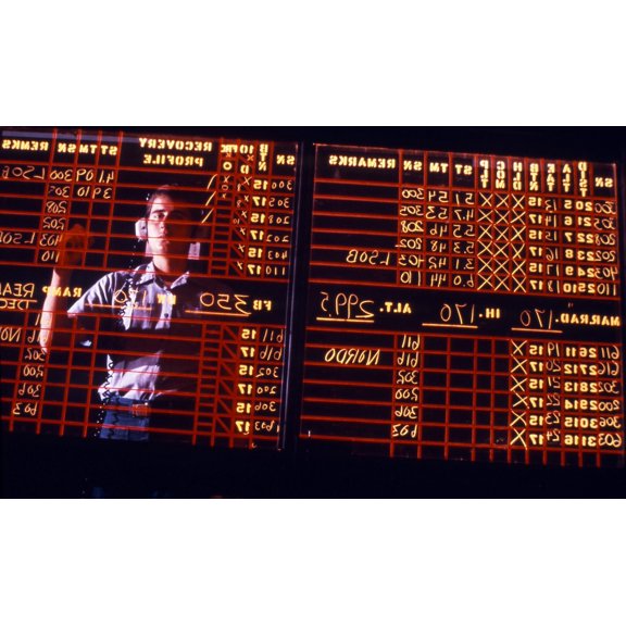 A student learns to write backwards on the air traffic control room status board Canvas Art - Michael WoodStocktrek Images (18 x 11)