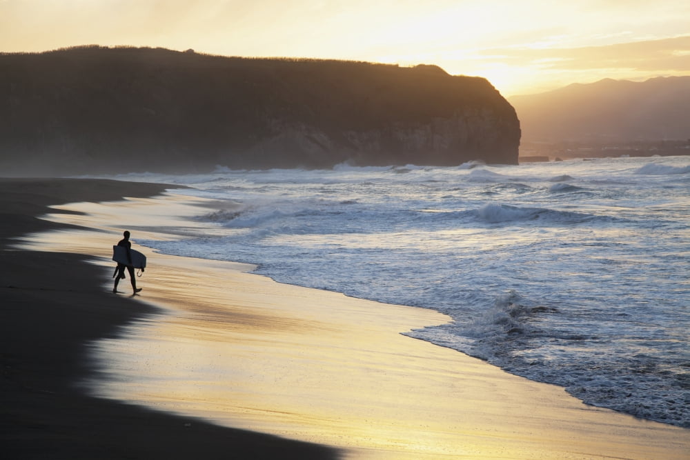 A surfer walks to the water at sunrise Santa Barbara Island Sao Miguel Island Acores Portugal Canvas Art - Carl Bruemmer Design Pics (38 x 24)