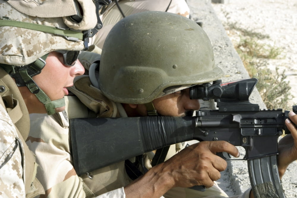 A team leader coaches a Marine as he fires an M16-A2 rifle Canvas Art - Stocktrek Images (34 x 23)