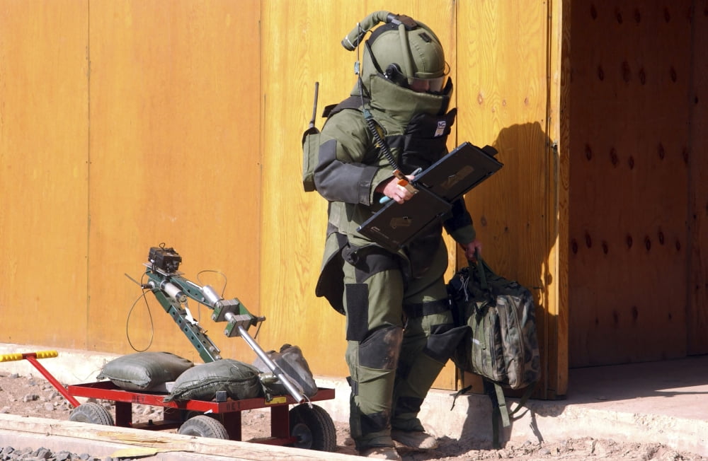 A technician from a Navy Explosive Ordnance Disposal Mobile Unit holding equipment Canvas Art - Stocktrek Images (34 x 23)