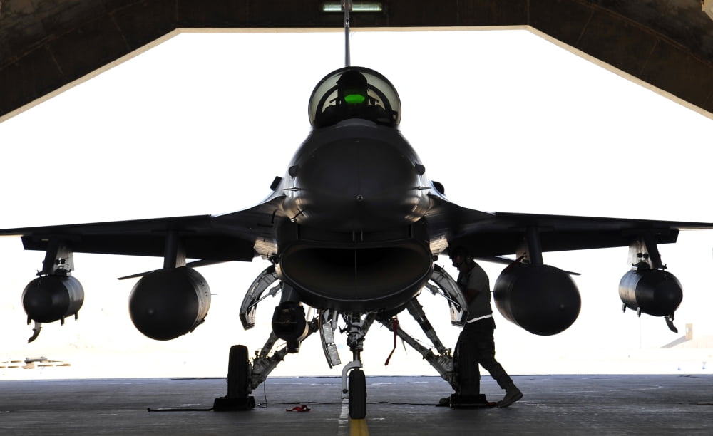 A technician performs a post flight check on an F-16 Fighting Falcon Canvas Art - Stocktrek Images (36 x 22)