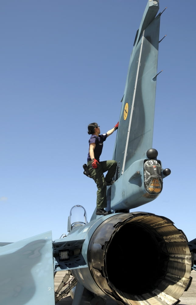 A technician performs post flight maintenance on a JASDF F-2 fighter aircraft Canvas Art - Stocktrek Images (23 x 35)