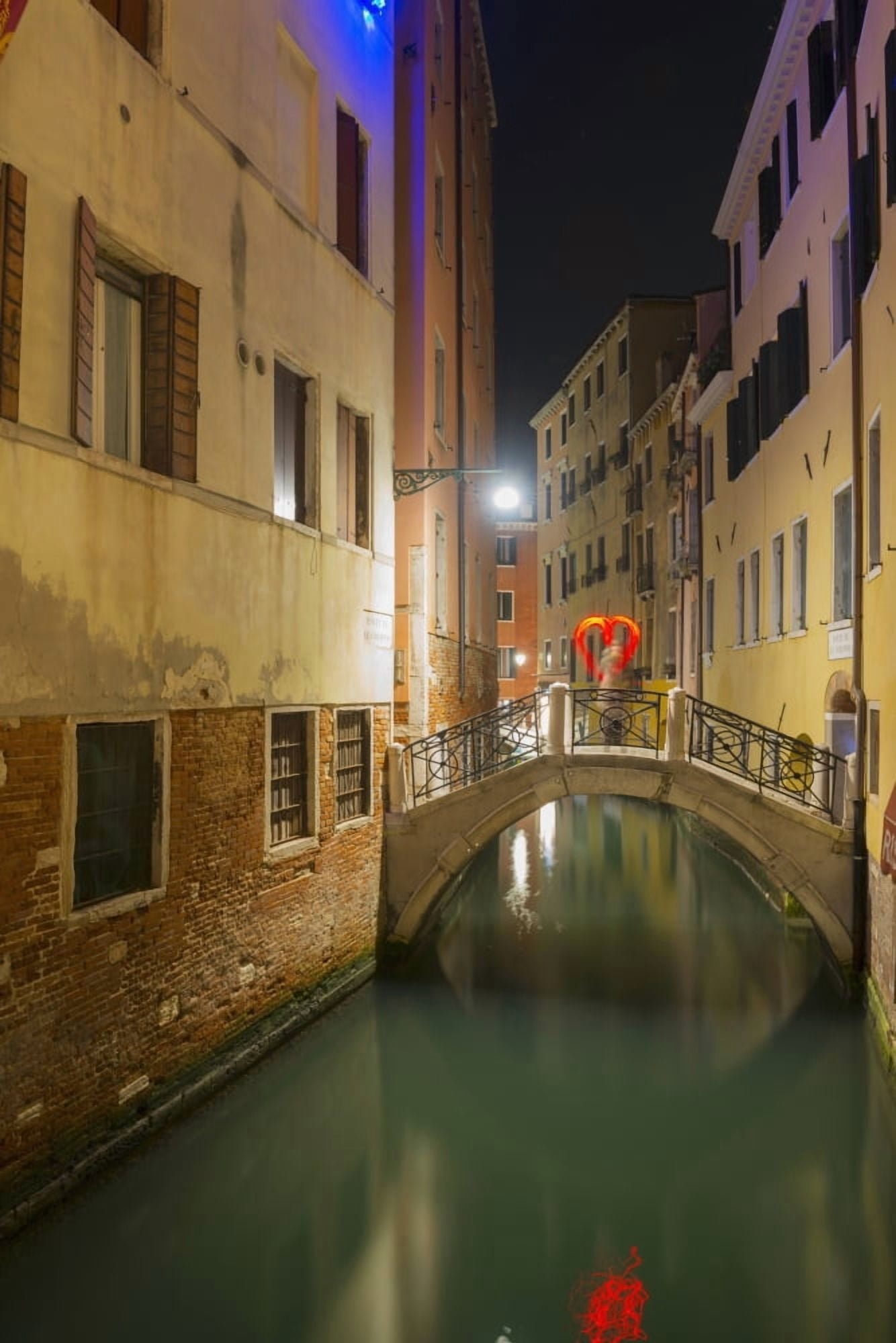 A tranquil canal between buildings with a heart shape on a footbridge Venice Veneto Italy Canvas Art - Mats Silvan Design Pics (24 x 38)