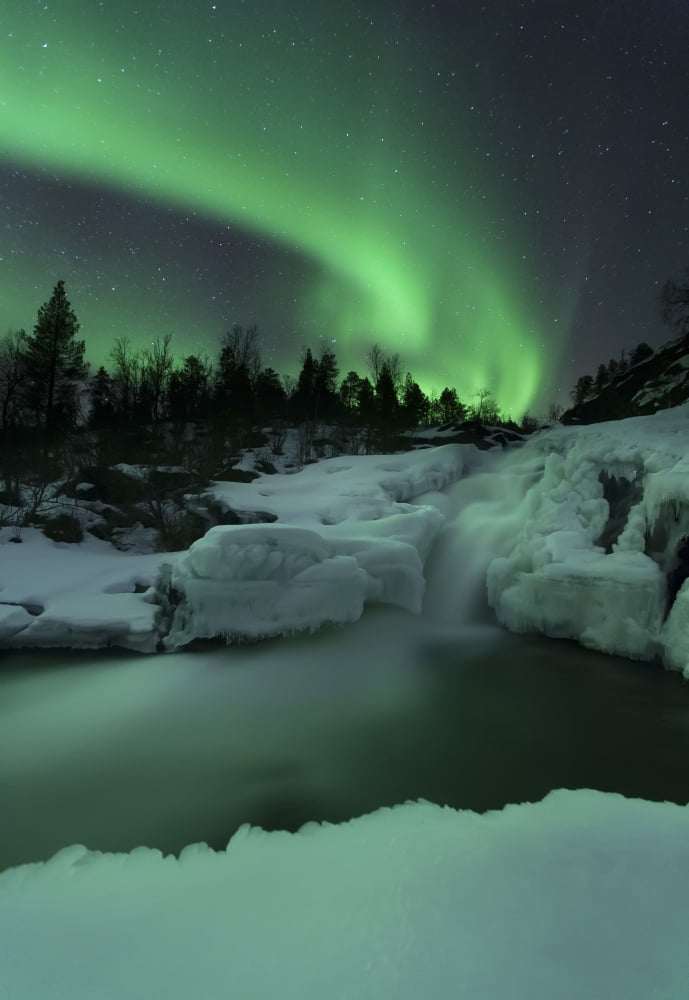 A wintery waterfall and aurora borealis over Tennevik River Norway Canvas Art - Arild HeitmannStocktrek Images (12 x 17)