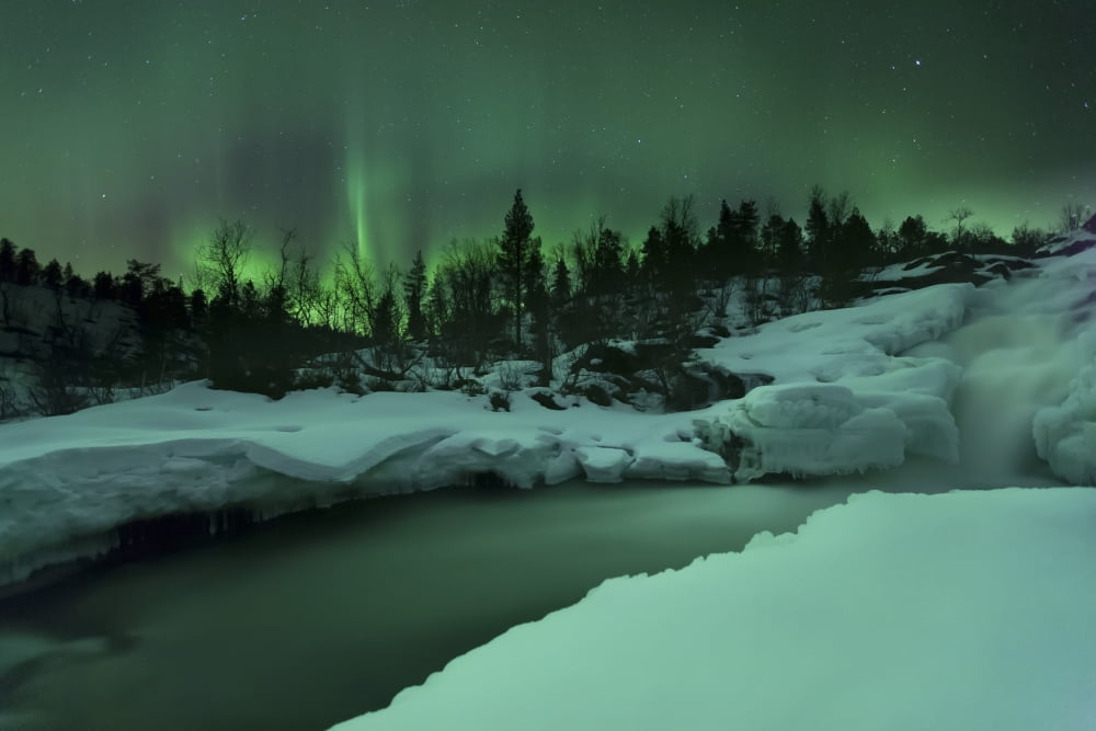 A wintery waterfall and aurora borealis over Tennevik River Norway Canvas Art - Arild HeitmannStocktrek Images (17 x 12)