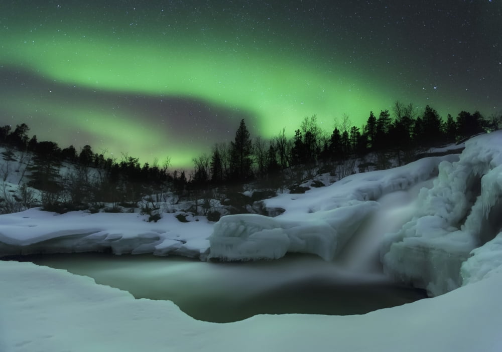 A wintery waterfall and aurora borealis over Tennevik River Norway Canvas Art - Arild HeitmannStocktrek Images (17 x 12)