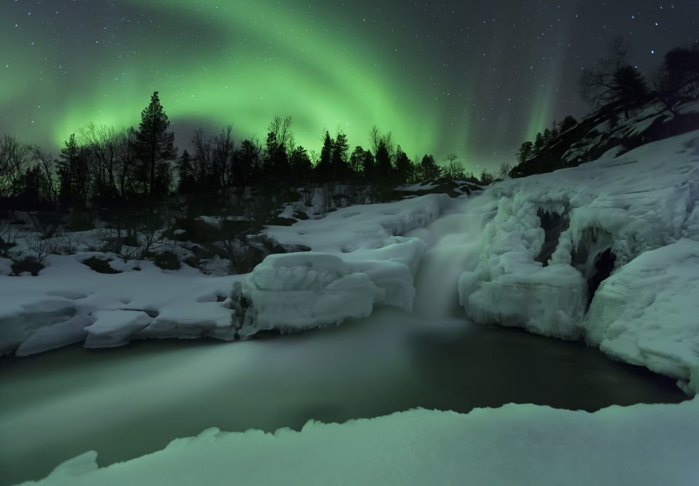 A wintery waterfall and aurora borealis over Tennevik River Norway Canvas Art - Arild HeitmannStocktrek Images (34 x 24)
