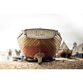 thumbnail image 1 of A wooden motorboat sits on the shingle beach with buildings in the background; England by Melody Davis / Design Pics, 1 of 3