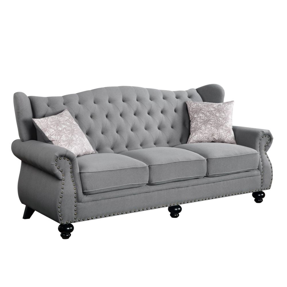 Gray Fabric Camelback Sofa with Floral Cushions and Nailhead Trim