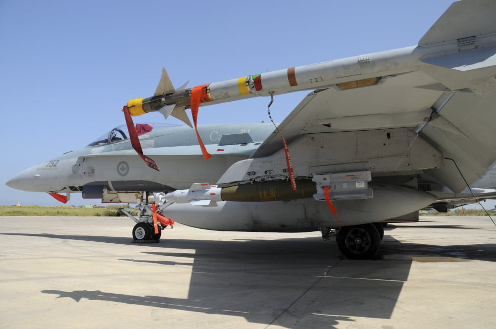 AIM-9L Sidewinder missile and GBU-12 Laser-Guided Bomb loaded on a CF-18 Hornet Canvas Art - Riccardo NiccoliStocktrek Images (34 x 23)