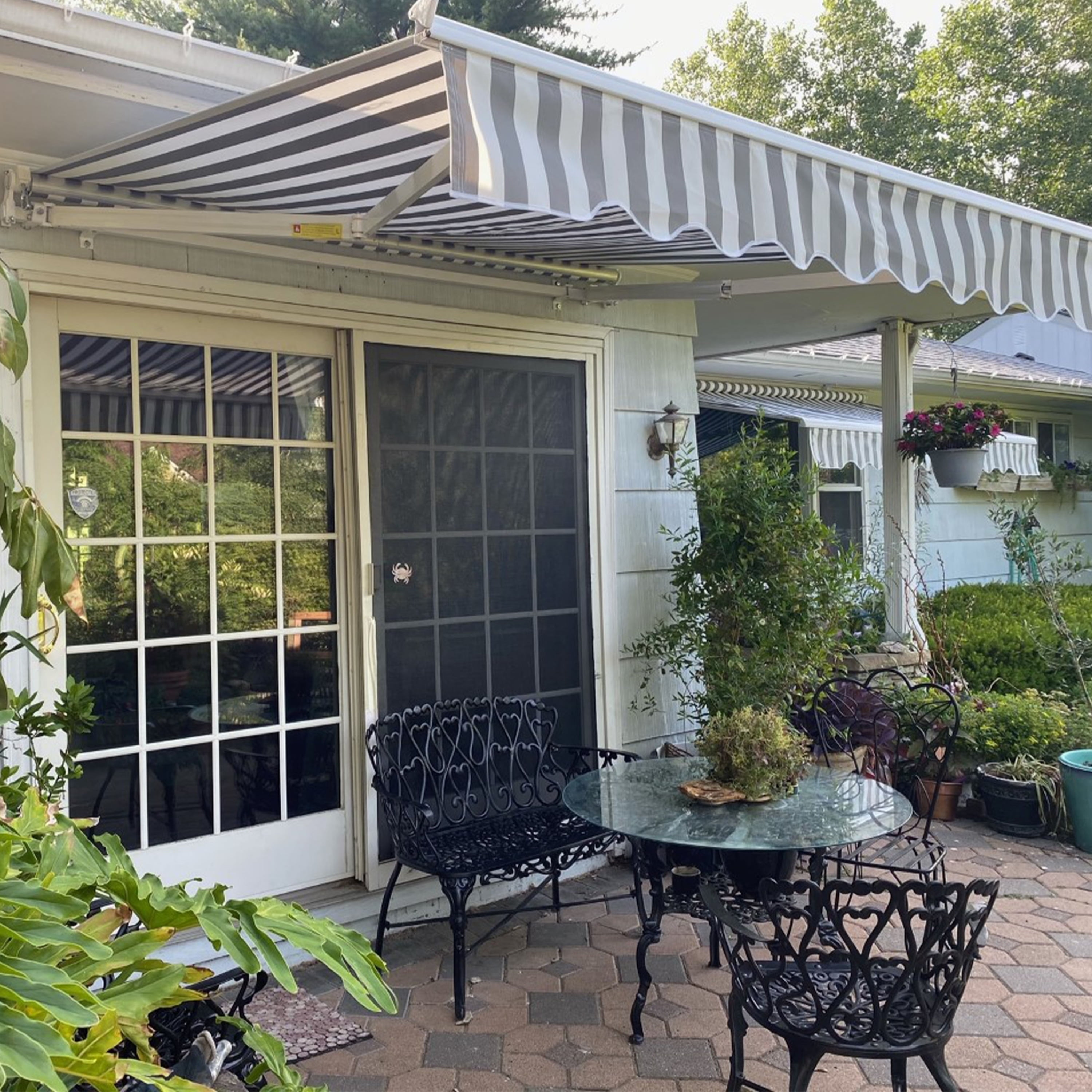 Grey and White Striped Retractable Patio Awning with White Frame