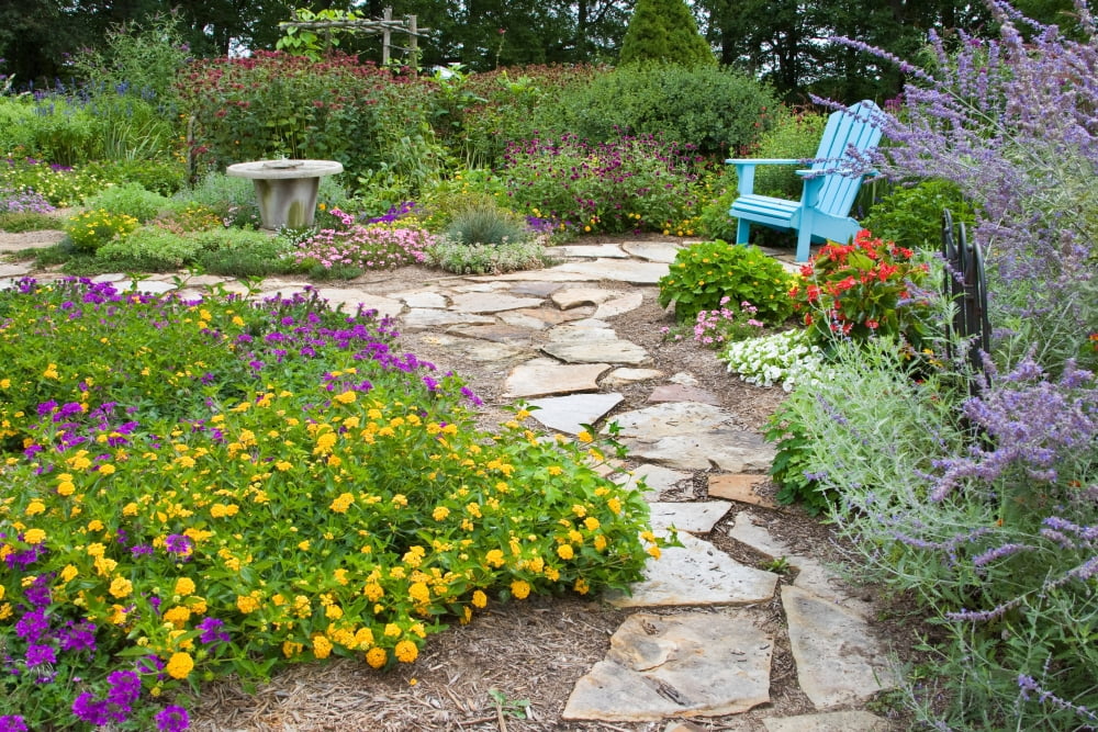 Adirondack chair and flowers in a garden Illinois USA Canvas Art - Panoramic Images (18 x 24)