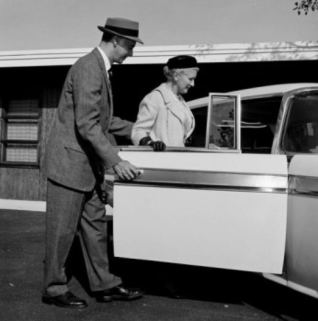 Adult son holding car door open before mother Canvas Art - (18 x 24)