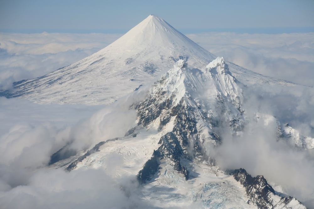 Aerial view of Shishaldin Volcano with Isanotski Peaks in foreground Alaska Canvas Art - Richard RoscoeStocktrek Images (18 x 12)