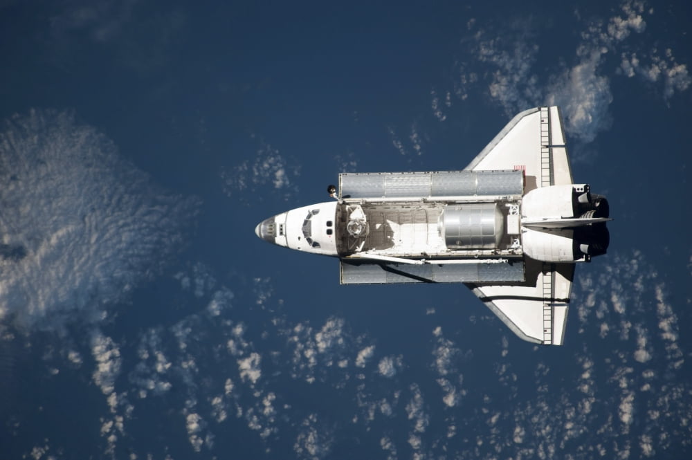 Aerial view of Space Shuttle Discovery over Earth as it approaches the International Space Station Canvas Art - Stocktrek Images (34 x 23)