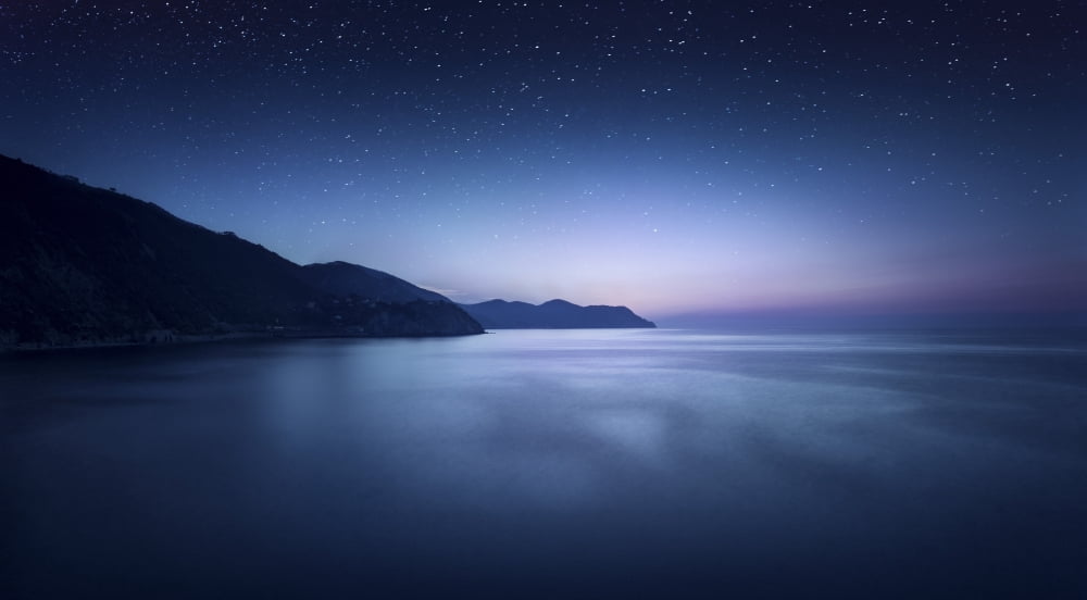 Aerial view of sea and mountains on a starry night Manarola Italy Canvas Art - Evgeny KuklevStocktrek Images (38 x 21)