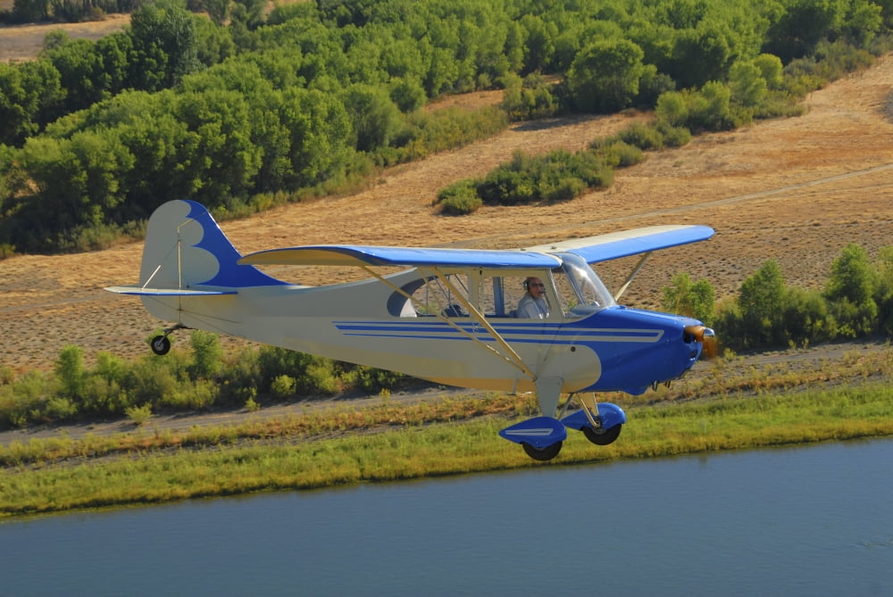 Aeronca 7AC Champion aircraft flying over Chico California Canvas Art - Phil WallickStocktrek Images (34 x 23)