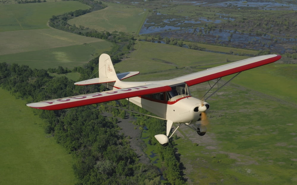 Aeronca Chief flying over Sacramento Valley California Canvas Art - Phil WallickStocktrek Images (18 x 11)