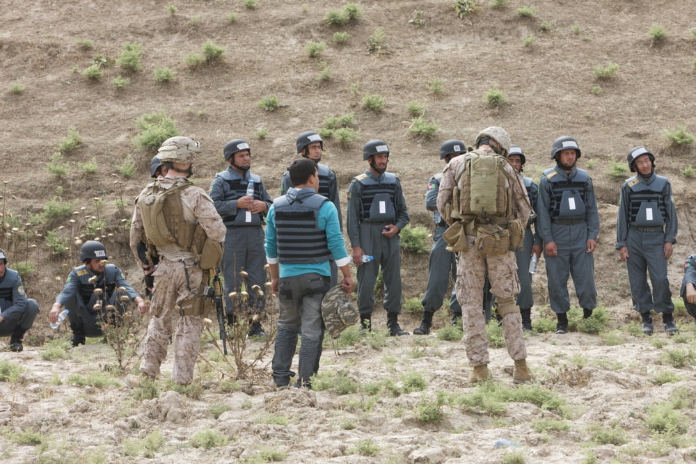 Afghan Police students listen to US Marines give instructions on firing range rules Canvas Art - Terry MooreStocktrek Images (18 x 12)