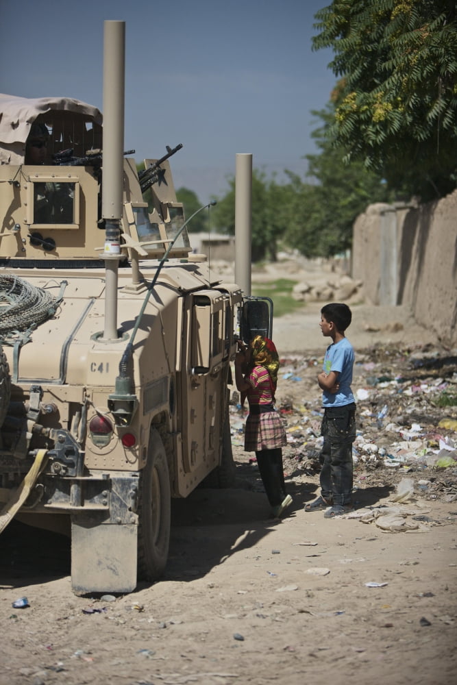 Afghan children ask US soldiers in their humvee for candy Canvas Art - Terry MooreStocktrek Images (12 x 18)