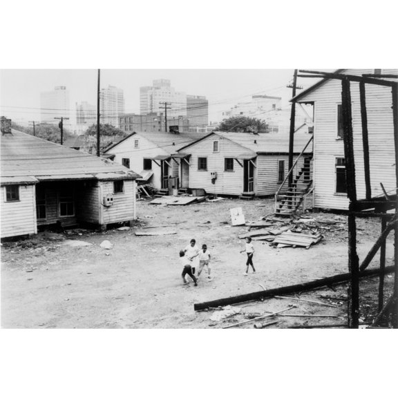 African American Children Playing In Slum In View Of High Rise Buildings In Background. North Carolina History