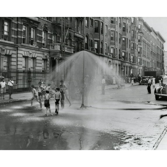 African American Children Playing In Water Sprayed From A Sprinkler In South Harlem History