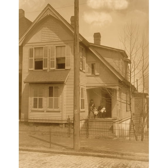 African American family posed on porch of house Poster Print (24 x 36)