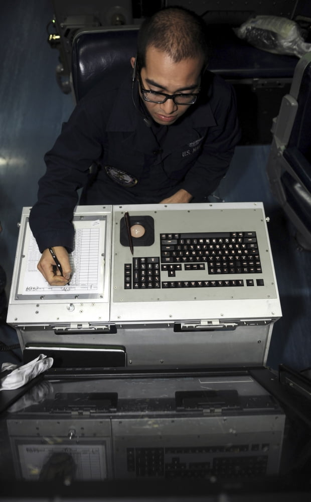 Air Traffic Controller records incoming aircraft inside the control center aboard USS John C Stennis Canvas Art - Stocktrek Images (22 x 36)