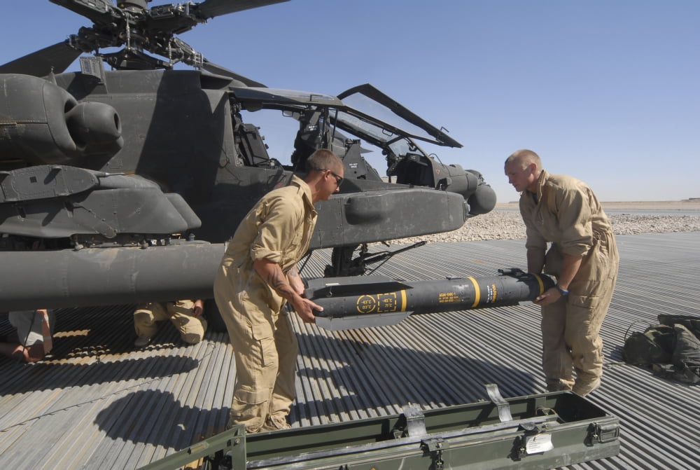 Aircrew loading an AGM-114 Hellfire missile onto an Apache helicopter Canvas Art - Andrew ChittockStocktrek Images (34 x 23)