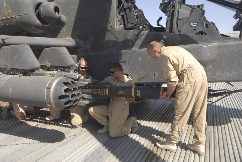Aircrew loading an AGM-114 Hellfire missile onto an Apache helicopter Canvas Art - Andrew ChittockStocktrek Images (34 x 23)