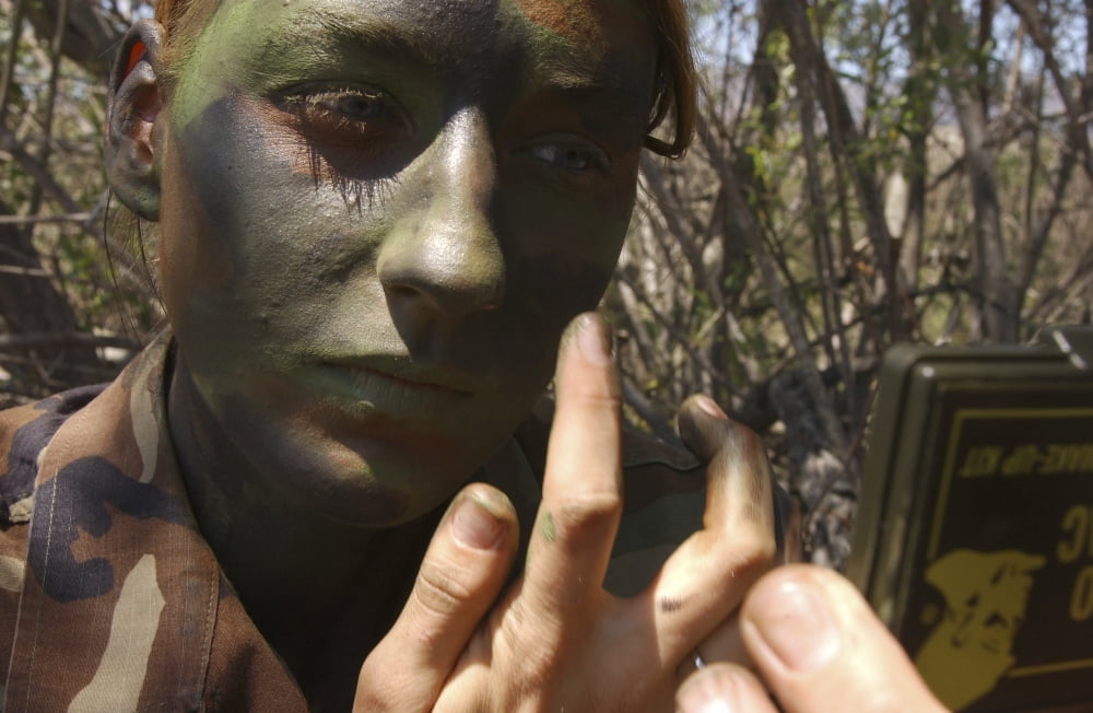Airman applies camouflage paint to her face Canvas Art - Stocktrek Images (34 x 22)