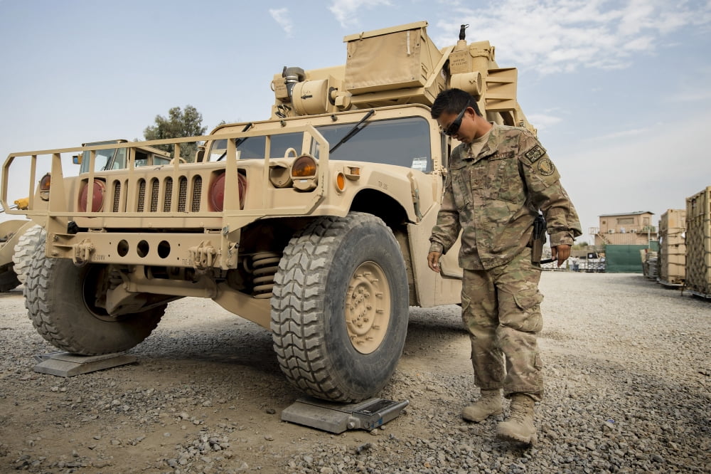 Airman checks the weight of a vehicle in Afghanistan Canvas Art - Stocktrek Images (35 x 23)