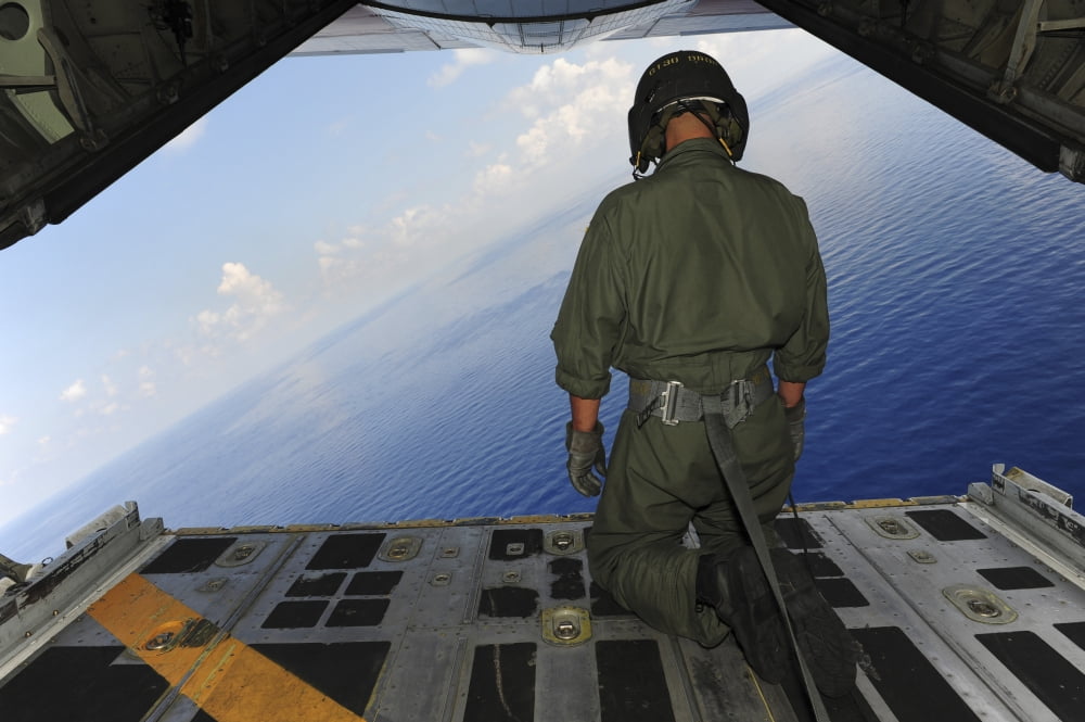 Airman observes the waters of the Gulf of Mexico from a C-130 Hercules Canvas Art - Stocktrek Images (34 x 23)