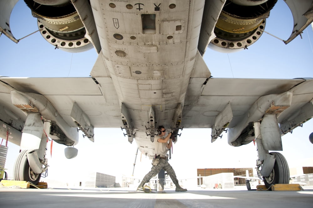 Airman performs an inspection and cleaning on an A-10 Thunderbolt Canvas Art - Stocktrek Images (34 x 23)