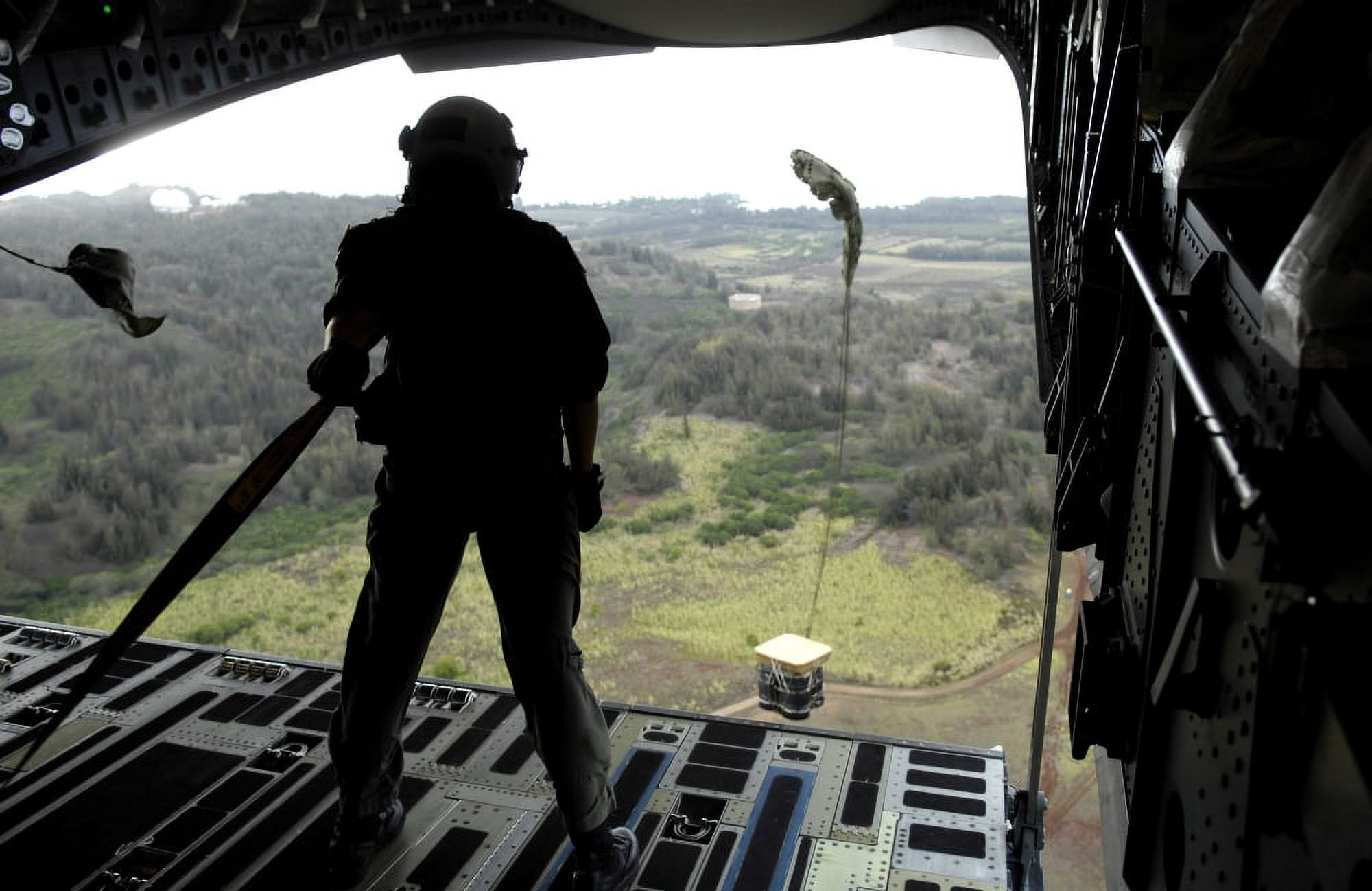 Airman watches a practice bundle fall from a C-17 Globemaster III Canvas Art - Stocktrek Images (34 x 22)