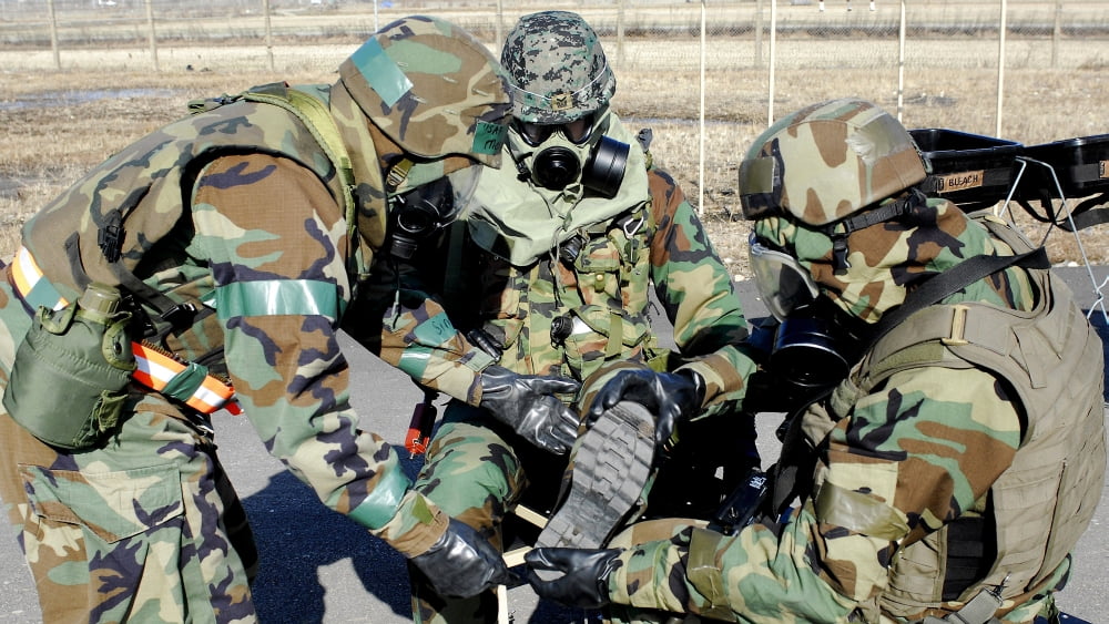 Airmen assist a Republic of Korea Army soldier with decontamination of his gears Canvas Art - Stocktrek Images (37 x 21)