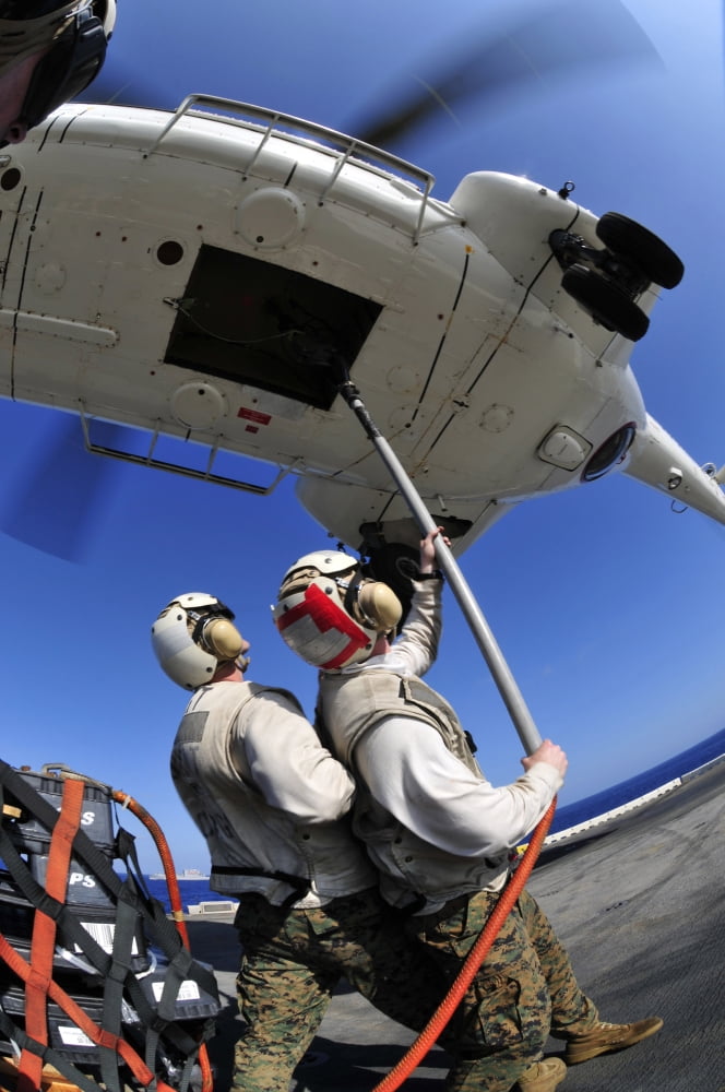 Airmen attach pallet rigs to an SA-330J Puma helicopter aboard USS Essex Canvas Art - Stocktrek Images (23 x 35)