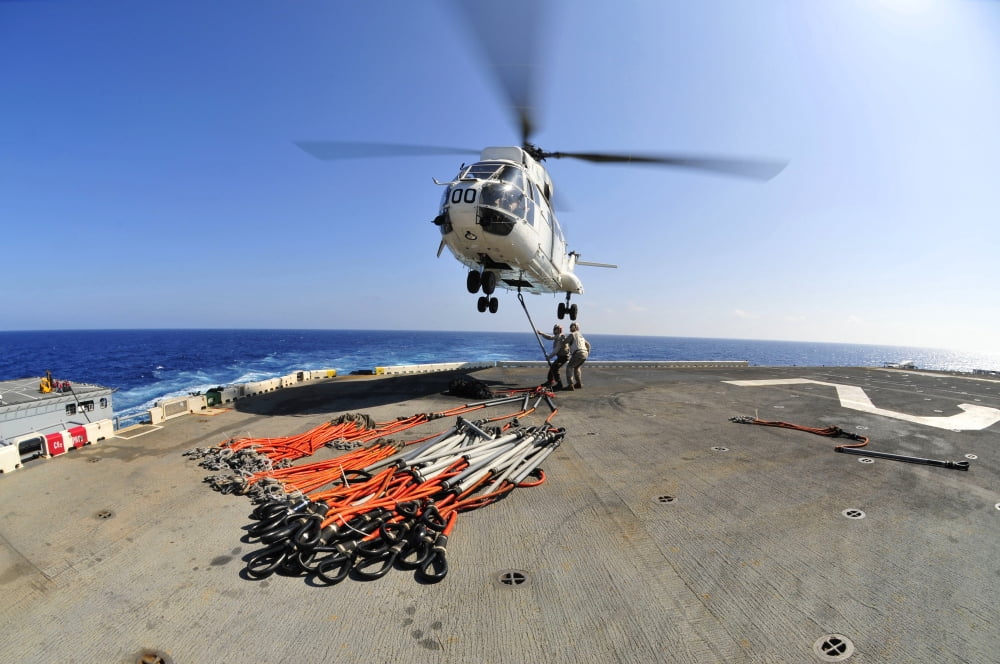 Airmen attach pallet rigs to an SA-330J Puma helicopter aboard USS Essex Canvas Art - Stocktrek Images (35 x 23)