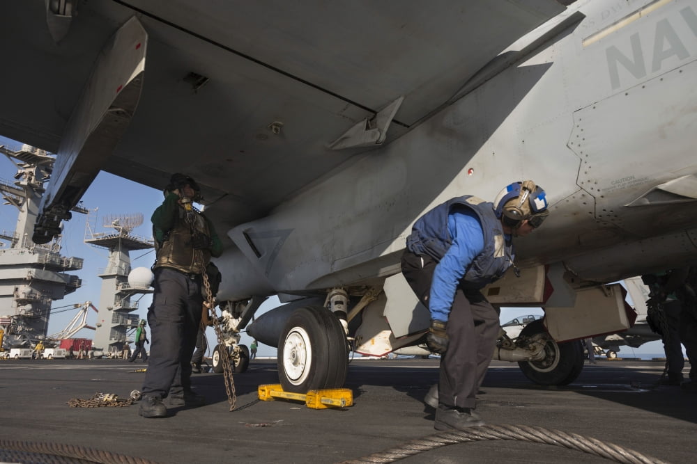 Airmen chain down an FA-18E Super Hornet Canvas Art - Gert KromhoutStocktrek Images (35 x 24)