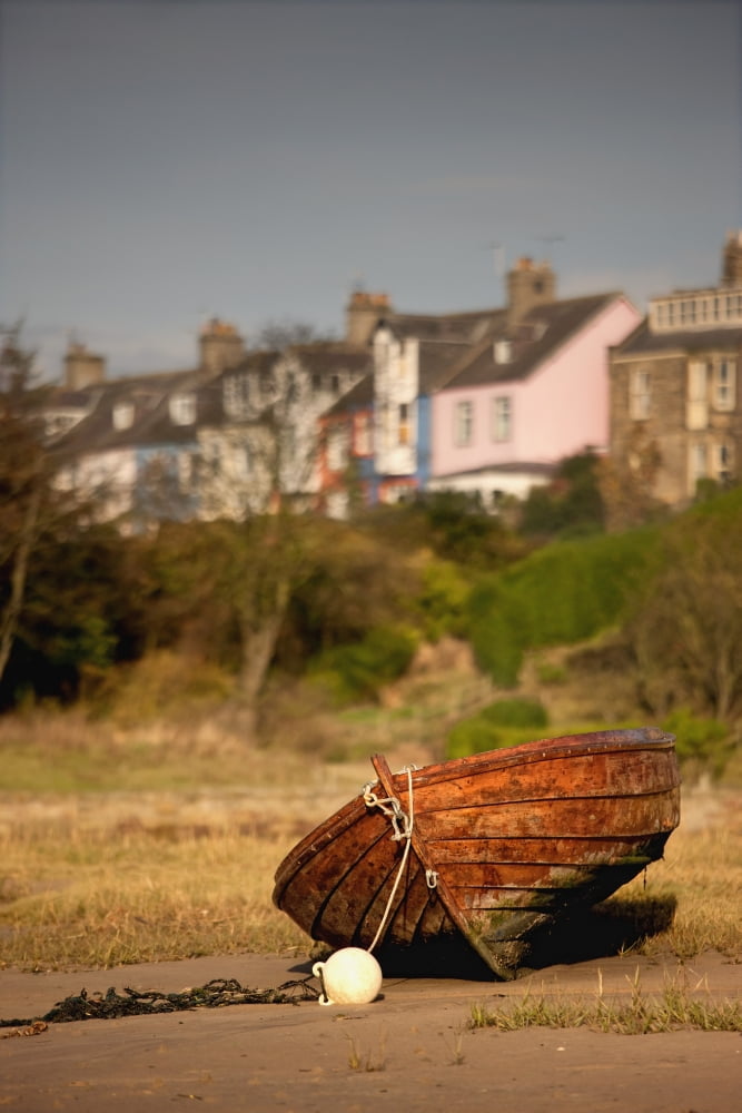 Alnmouth Northumberland England An Abandoned Rusted Boat Sitting On Land With Houses In The Background Canvas Art - John Short Design Pics (24 x 38)