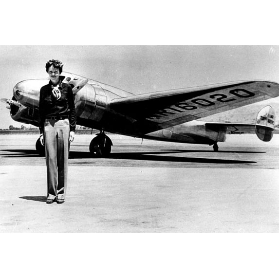 Amelia Earhart by an airplane Photo Print (30 x 24)