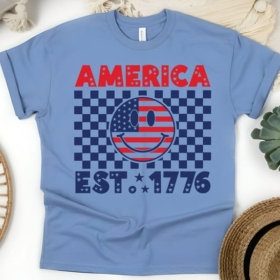 America EST 1776 Smiley Face Shirt – USA Flag Checkerboard Patriotic Tee, CarolinaBlue, Size 2XL
